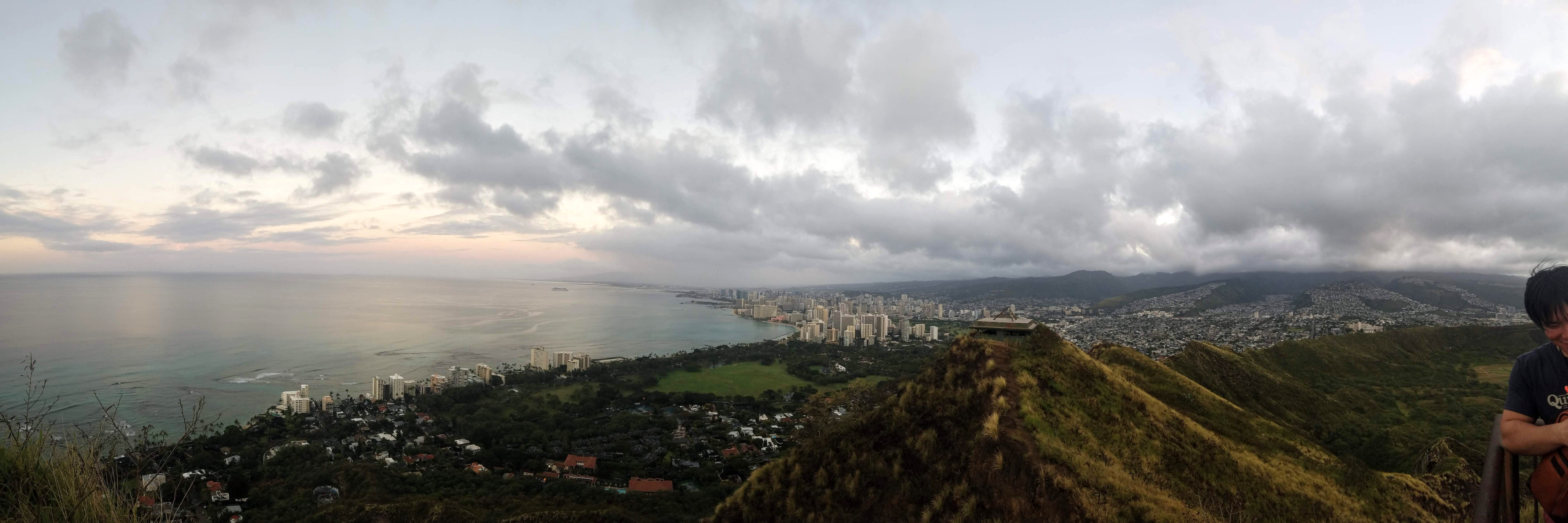 the view from the top of Diamond Head crater. this view is facing Waikiki. The ocean is to the left and the beach and Waikiki is to the right.
